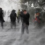 Members of the press, including NBC’s Dixon, face the blowing snow caused by Marine One as it landed on the South Lawn before picking up U.S. President Barack Obama at the White House in Washington