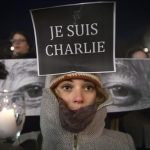 People take part in a vigil to pay tribute to the victims of a shooting, by gunmen at the offices of weekly satirical magazine Charlie Hebdo in Paris, in the Manhattan borough of New York